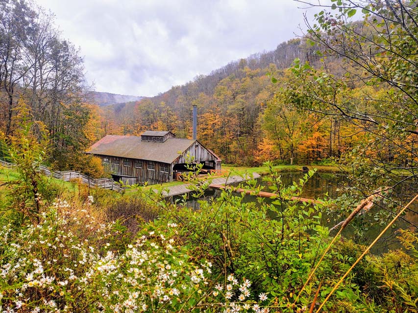 Antique Sawmill in the middle of the mountains covered with fall foliage
