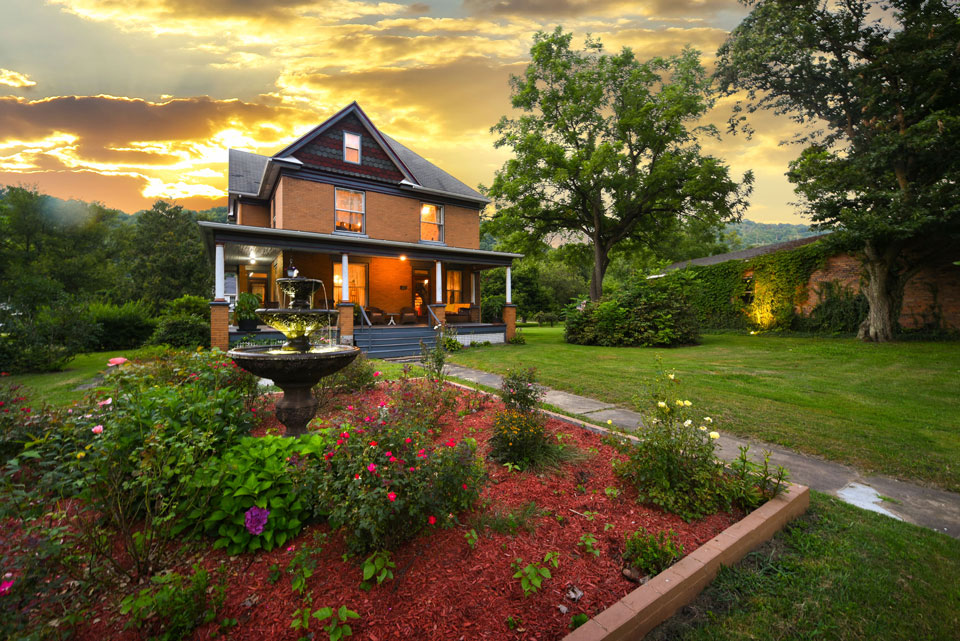 A retreat house with a pond and trees on beautiful evening