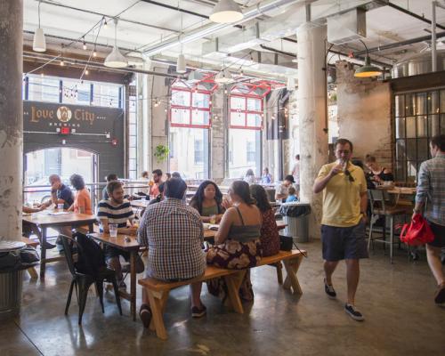 people enjoying beer inside brewery